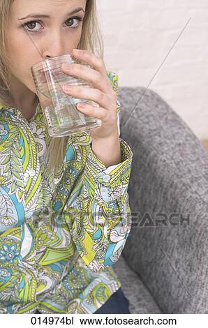 young woman drinking glass of water View Large Photo Image Stock Image - young woman drinking glass of water. Fotosearch