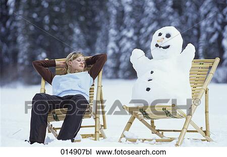 young woman relaxing on deck chair in snow together with snowman View Large Photo Image Stock Image - young woman relaxing on deck chair in snow together with snowman. Fotosearch