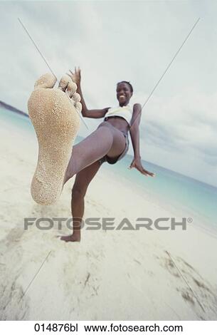 young woman showing her foot on sandy beach View Large Photo Image Stock Image - young woman showing her foot on sandy beach. Fotosearch