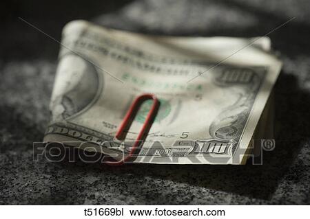 100$ bills wrapped with a red clip View Large Photo Image Stock Image - 100$ bills wrapped with a red clip. Fotosearch