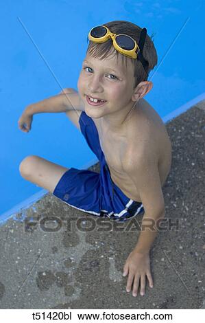 9 year old boy sitting at the edge of the swimming pool View Large Photo Image Stock Image - 9 year old boy sitting at the edge of the swimming pool. Fotosearch
