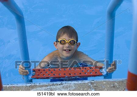 Stock Image - 9 year old boy swimming in pool. Fotosearch