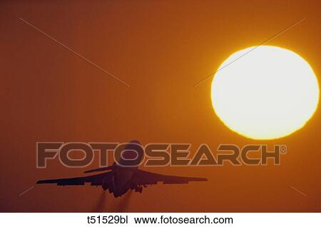 Airplane flying through sunset View Large Photo Image Stock Image - Airplane flying through sunset. Fotosearch