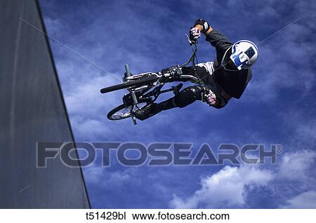 Bicycle, acrobatic exhibition View Large Photo Image Stock Image - Bicycle, acrobatic exhibition. Fotosearch