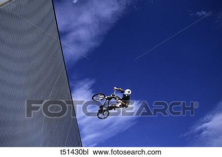 Bicycle, acrobatic exhibition View Large Photo Image Stock Image - Bicycle, acrobatic exhibition. Fotosearch