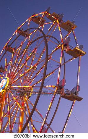 Big wheel spinning in the early evening View Large Photo Image Stock Image - Big wheel spinning in the early evening. Fotosearch