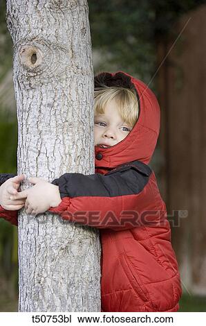 Boy embracing tree View Large Photo Image Stock Image - Boy embracing tree. Fotosearch