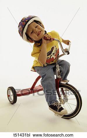 Boy on tricycle View Large Photo Image Stock Image - Boy on tricycle. Fotosearch