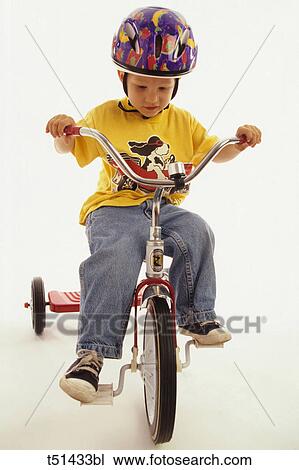 Boy on tricycle View Large Photo Image Stock Image - Boy on tricycle. Fotosearch
