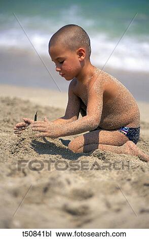 Boy playing at the beach View Large Photo Image Stock Image - Boy playing at the beach. Fotosearch