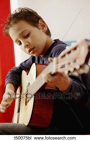 Boy playing guitar View Large Photo Image Stock Image - Boy playing guitar. Fotosearch