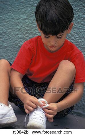 Boy tying up his shoe laces View Large Photo Image Stock Image - Boy tying up his shoe laces. Fotosearch