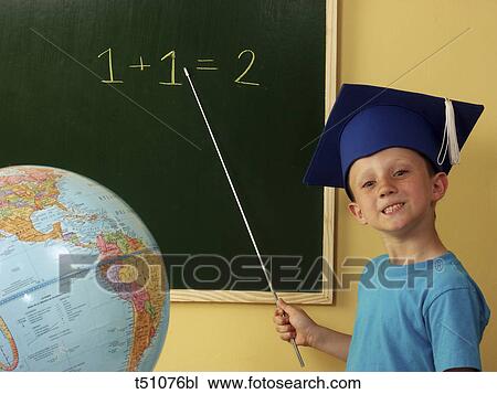 Boy wearing graduate cap standing in front of blackboard View Large Photo Image Stock Image - Boy wearing graduate cap standing in front of blackboard. Fotosearch