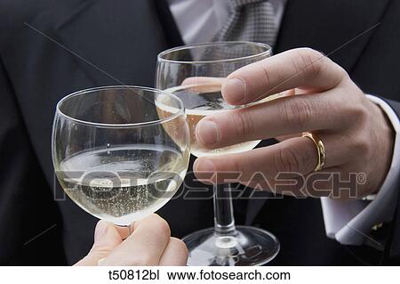 Bride and groom toasting with champagne View Large Photo Image Stock Image - Bride and groom toasting with champagne. Fotosearch