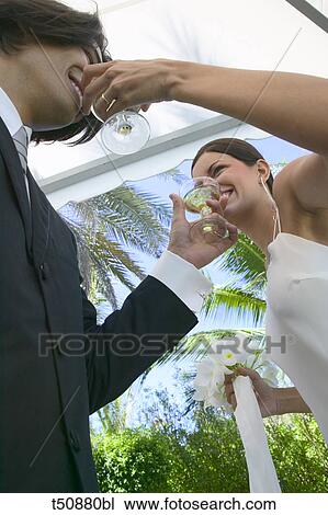 Stock Image - Bride and groom toasting with champagne. Fotosearch