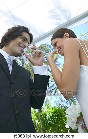Stock Image - Bride and groom toasting with champagne. Fotosearch