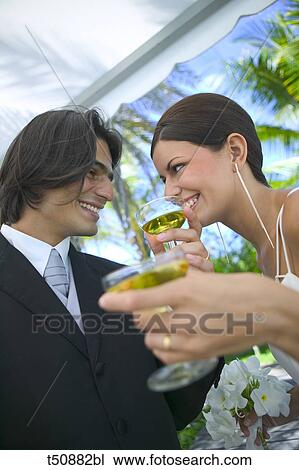 Bride and groom toasting with champagne View Large Photo Image Stock Image - Bride and groom toasting with champagne. Fotosearch