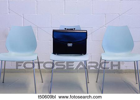 Stock Image - Briefcase on chair. Fotosearch