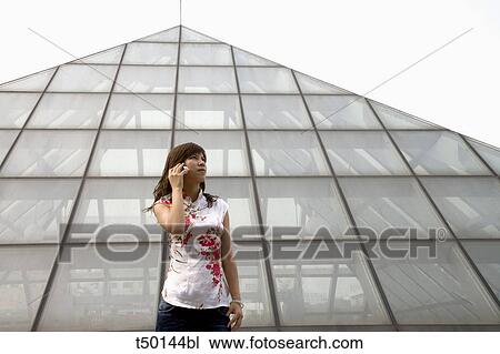 Chinese woman talking on mobile phone View Large Photo Image Stock Image - Chinese woman talking on mobile phone. Fotosearch