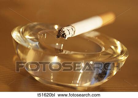 Stock Image - Cigarette on ashtray. Fotosearch