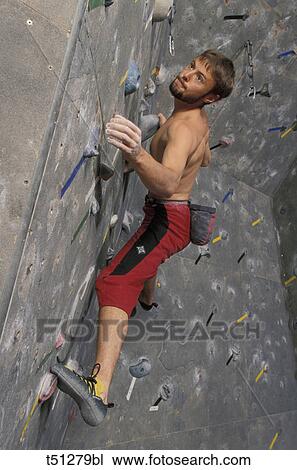 Climbing, man on training wall View Large Photo Image Stock Image - Climbing, man on training wall. Fotosearch