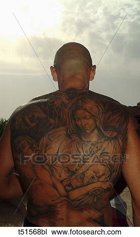 Stock Image - Close up of man`s back with tattoos. Fotosearch