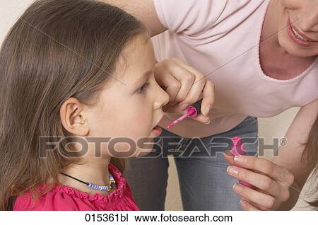 close-up of mother applying some lipgloss on her daughter´s mouth View Large Photo Image Stock Image - close-up of mother applying some lipgloss on her daughter´s mouth. Fotosearch