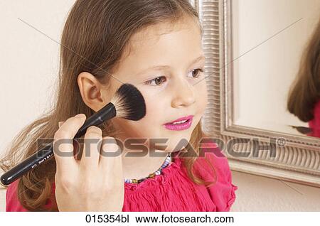 close-up of young girl being made up by her mother View Large Photo Image Stock Image - close-up of young girl being made up by her mother. Fotosearch