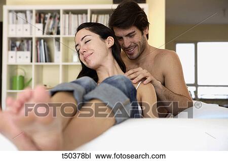 Couple at home: man massaging woman's shoulders View Large Photo Image Stock Image - Couple at home: man massaging woman's shoulders. Fotosearch