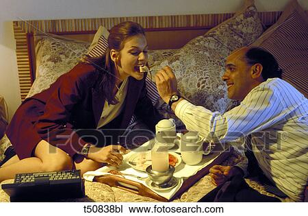 Couple eating in bed View Large Photo Image Stock Image - Couple eating in bed. Fotosearch