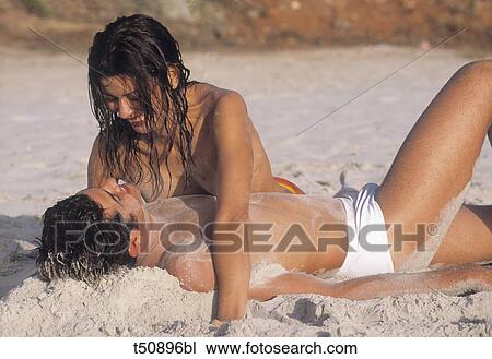 Couple having fun on beach View Large Photo Image Stock Image - Couple having fun on beach. Fotosearch