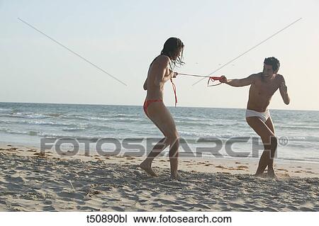 Couple having fun on the beach View Large Photo Image Stock Image - Couple having fun on the beach. Fotosearch