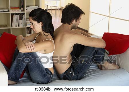Couple in disagreement sitting on sofa View Large Photo Image Stock Image - Couple in disagreement sitting on sofa. Fotosearch