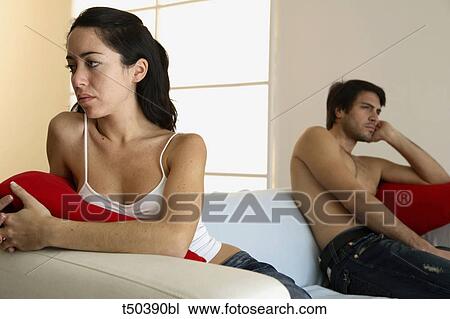Couple in disagreement sitting on sofa View Large Photo Image Stock Image - Couple in disagreement sitting on sofa. Fotosearch