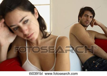 Couple in disagreement sitting on sofa View Large Photo Image Stock Image - Couple in disagreement sitting on sofa. Fotosearch