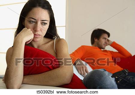 Couple in disagreement sitting on sofa View Large Photo Image Stock Image - Couple in disagreement sitting on sofa. Fotosearch