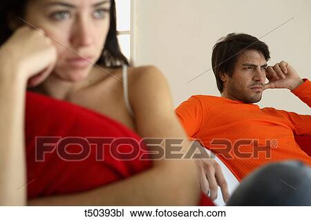 Couple in disagreement sitting on sofa View Large Photo Image Stock Image - Couple in disagreement sitting on sofa. Fotosearch