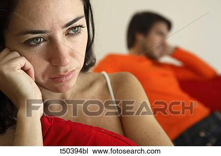 Couple in disagreement sitting on sofa View Large Photo Image Stock Image - Couple in disagreement sitting on sofa. Fotosearch