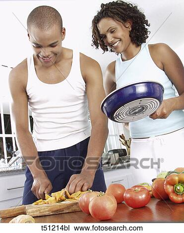 Couple in the kitchen preparing food View Large Photo Image Stock Image - Couple in the kitchen preparing food. Fotosearch