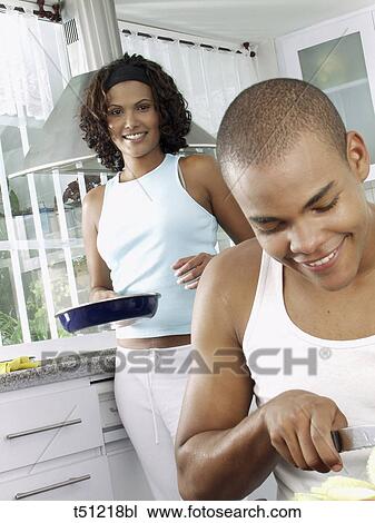Couple in the kitchen preparing food View Large Photo Image Stock Image - Couple in the kitchen preparing food. Fotosearch
