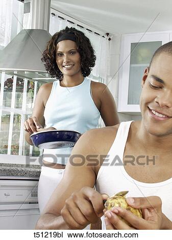Couple in the kitchen preparing food View Large Photo Image Stock Image - Couple in the kitchen preparing food. Fotosearch