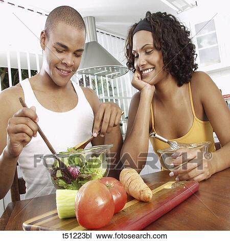 Couple in the kitchen preparing food View Large Photo Image Stock Image - Couple in the kitchen preparing food. Fotosearch