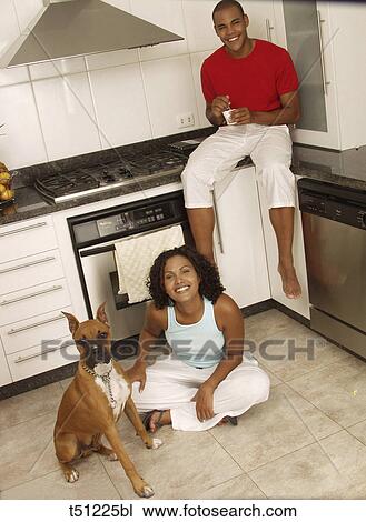 Couple in the kitchen with dog View Large Photo Image Stock Image - Couple in the kitchen with dog. Fotosearch
