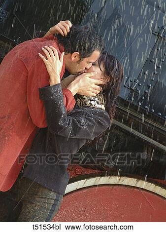 Couple kissing under rain View Large Photo Image Stock Image - Couple kissing under rain. Fotosearch