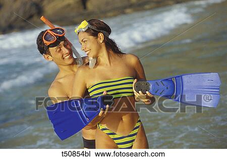 Couple playing on the beach View Large Photo Image Stock Image - Couple playing on the beach. Fotosearch