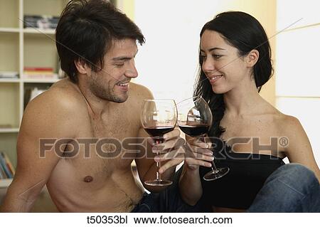 Couple toasting with red wine View Large Photo Image Stock Image - Couple toasting with red wine. Fotosearch
