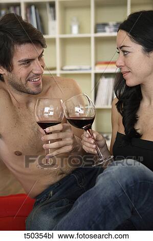 Couple toasting with red wine View Large Photo Image Stock Image - Couple toasting with red wine. Fotosearch
