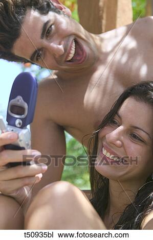 Couple's close up with mobile View Large Photo Image Stock Image - Couple's close up with mobile. Fotosearch