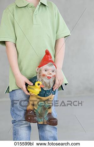 detail of boy holding garden gnome View Large Photo Image Stock Image - detail of boy holding garden gnome. Fotosearch