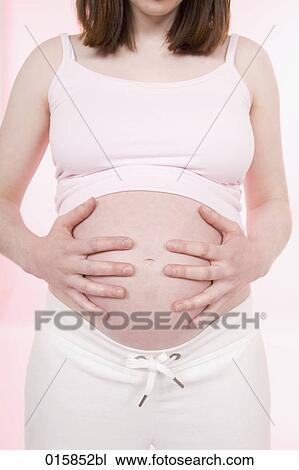 detail of pregnant young woman holding her belly View Large Photo Image Stock Image - detail of pregnant young woman holding her belly. Fotosearch
